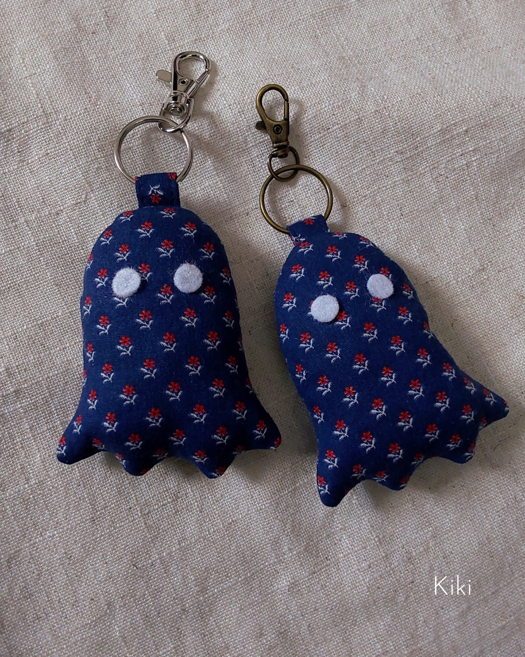 front view of calico navy cotton upcycled ghost keychains laying flat