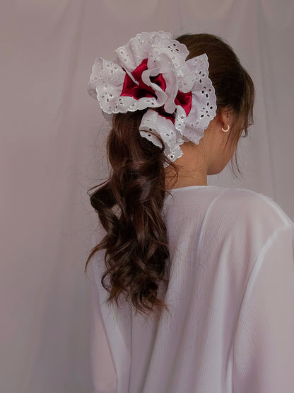 side view of white lace red satin upcycled scrunchie on model