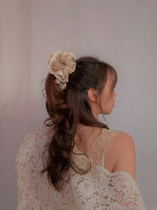 side view of beige lace upcycled scrunchie on model