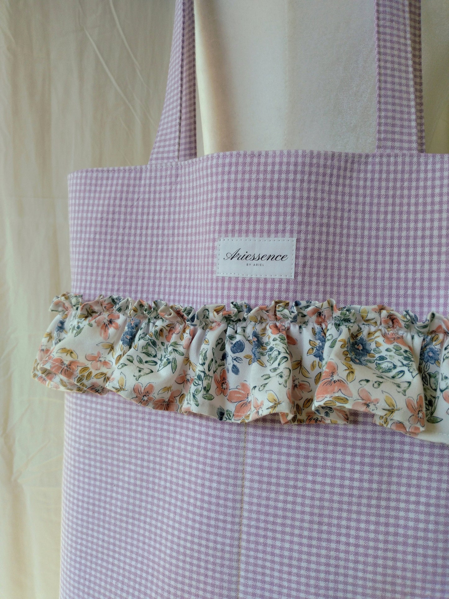 close up of purple gingham ruffle tote bag on mannequin