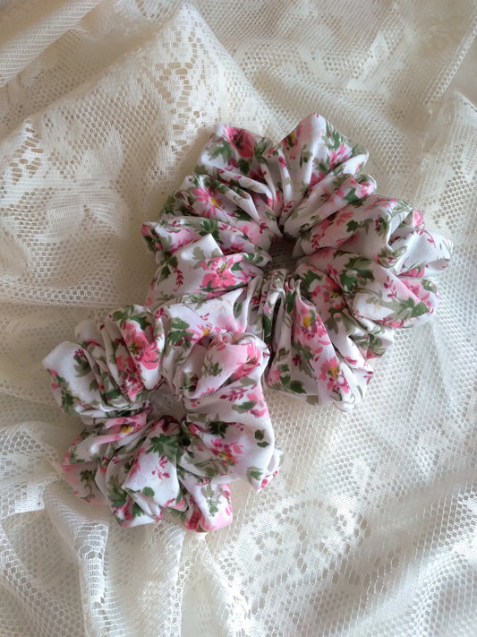 front view of pink floral cotton polyester upcycled scrunchies laying down size comparison