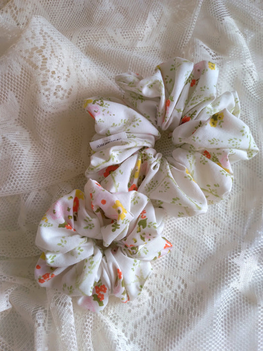 front view of floral white cotton upcycled scrunchies laying down size comparison