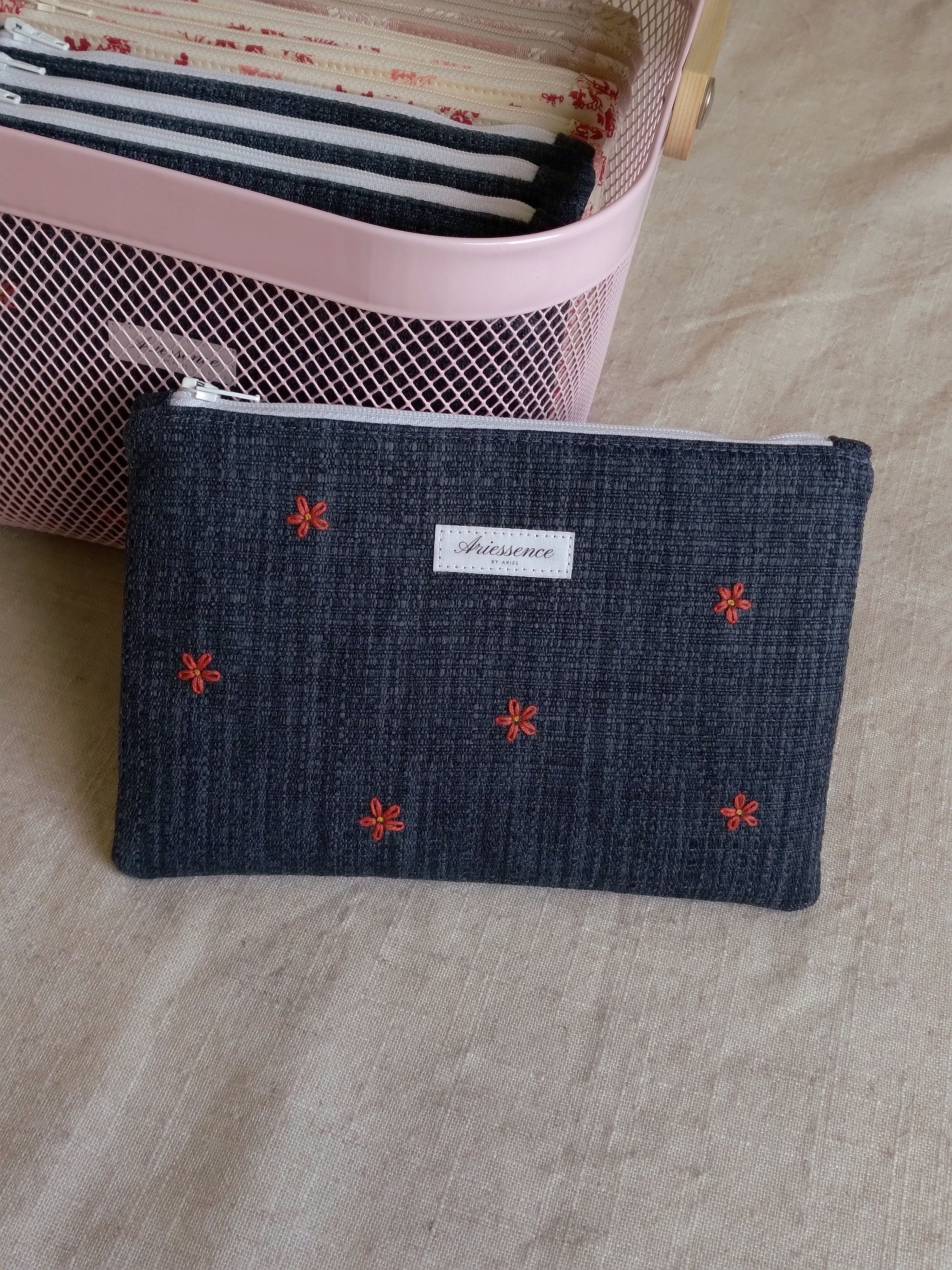 front view of hand embroidered daisy upcycled pouch