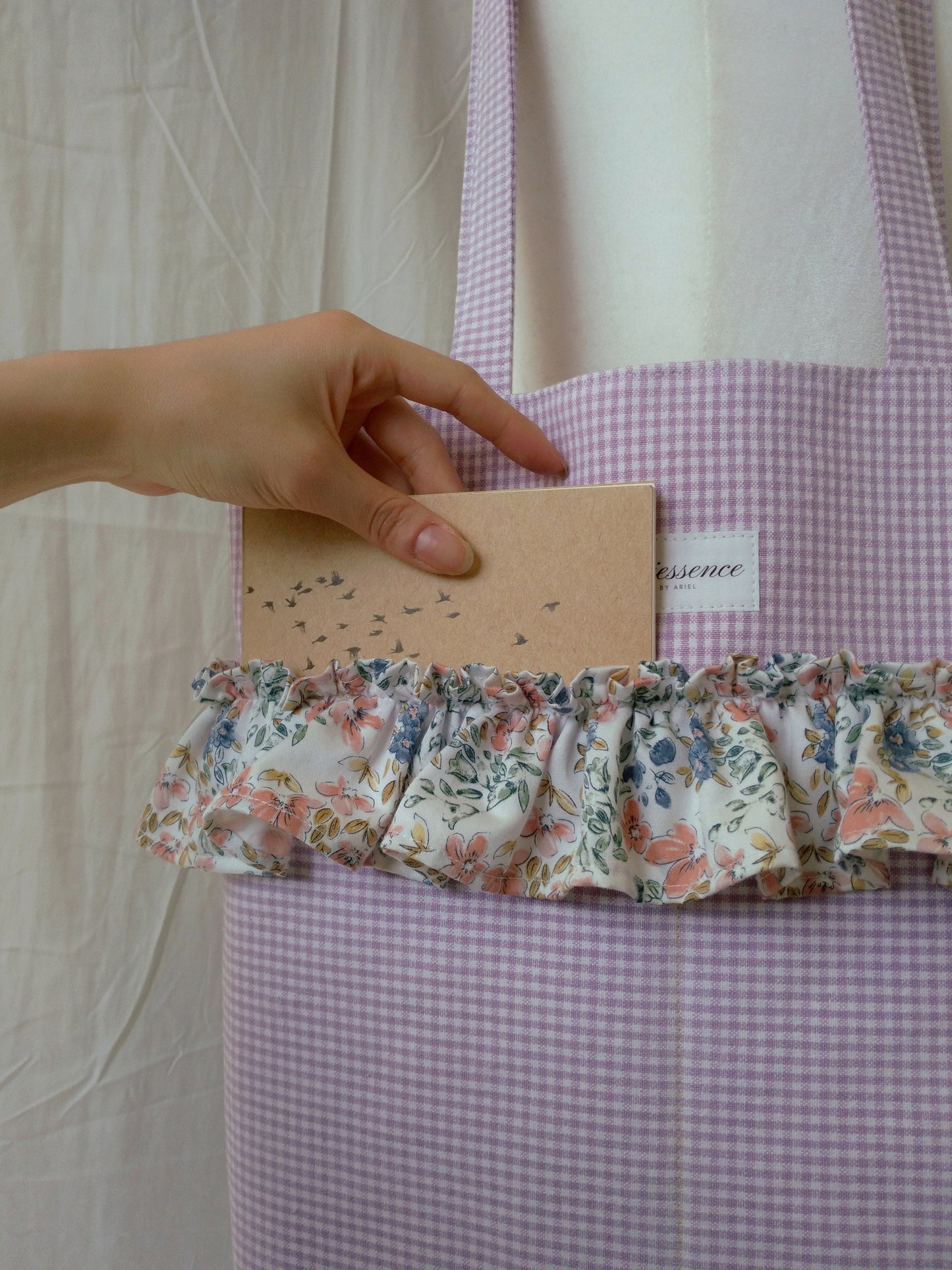 front view of exterior pockets on the purple gingham ruffle tote bag