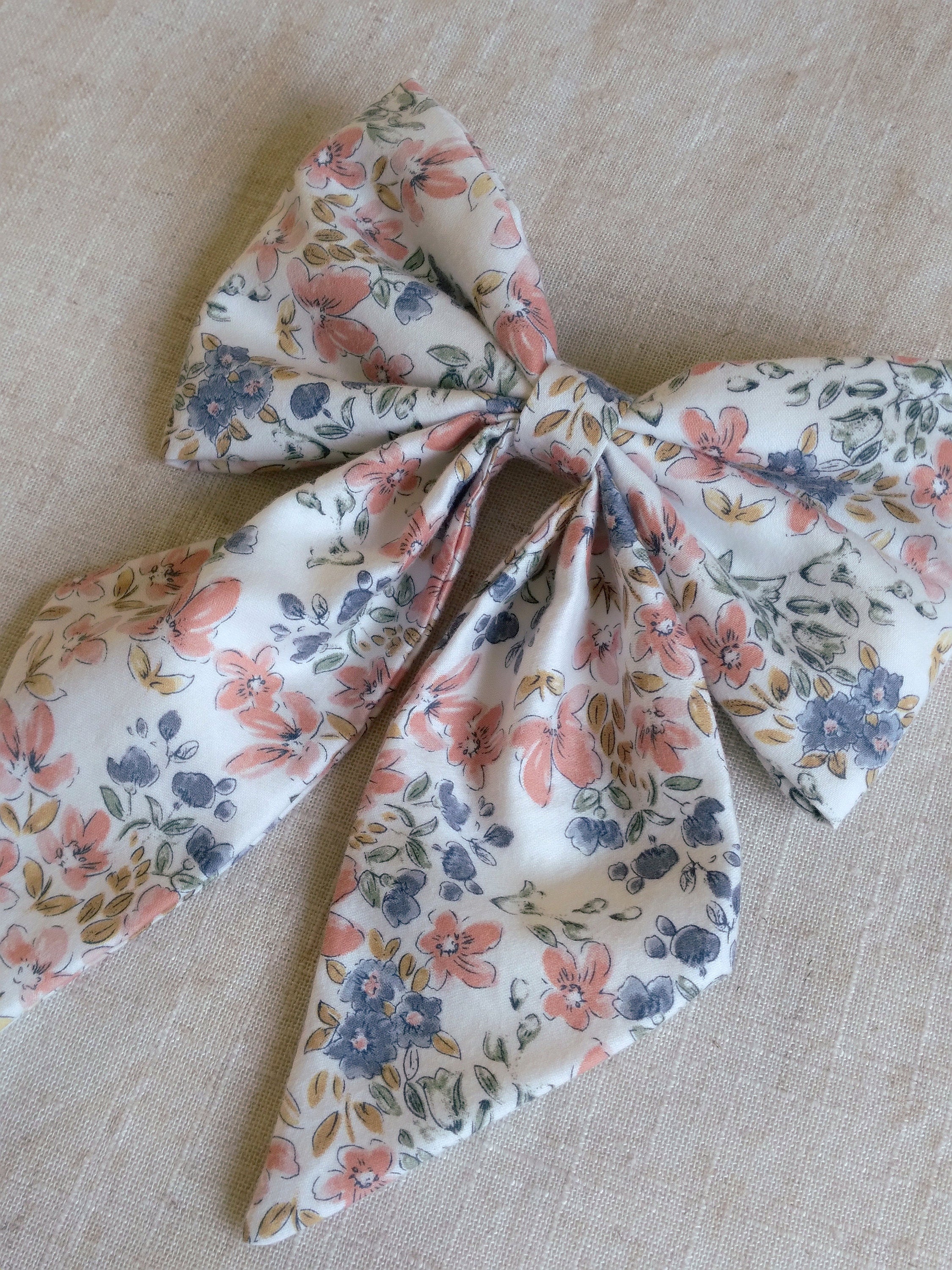 close up of floral cotton upcycled hair bow laying flat