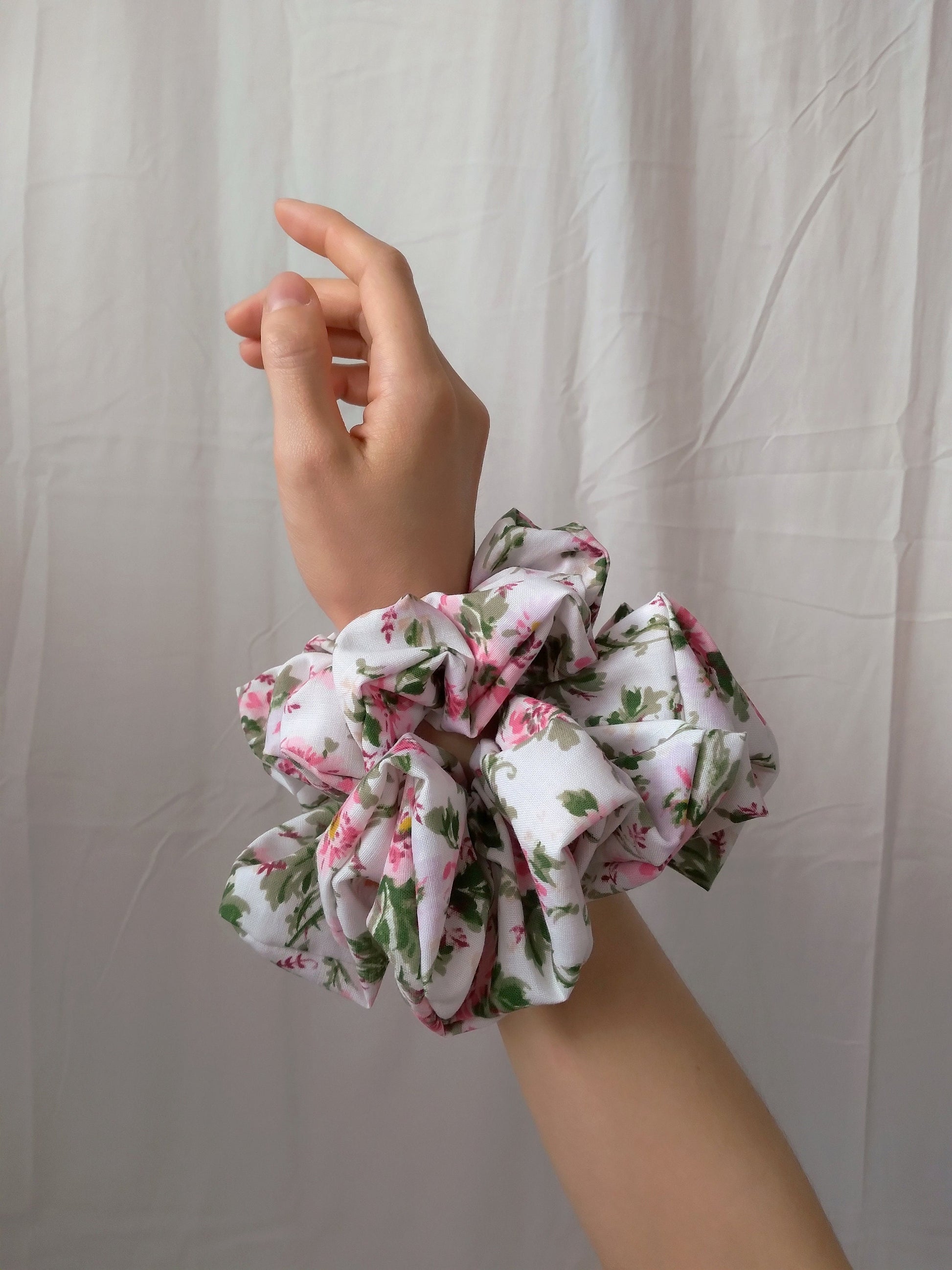 side view of pink floral cotton polyester upcycled scrunchies on wrist