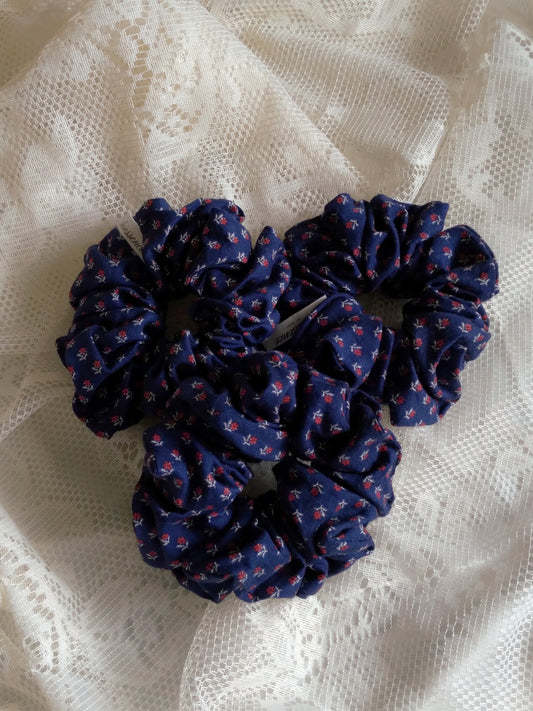 front view of calico navy cotton upcycled scrunchies laying down