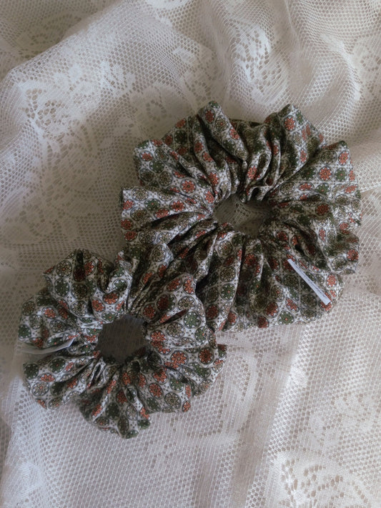 front view of floral green cotton upcycled scrunchies laying down size comparison