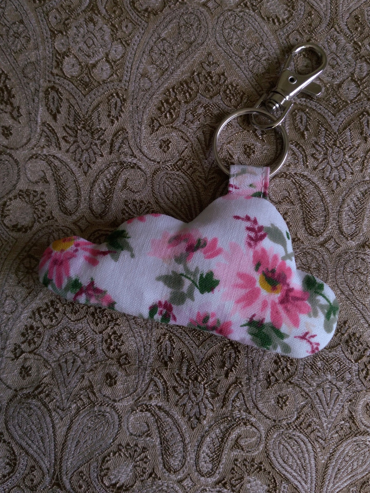 front view of pink florals white upcycled cloud keychain laying flat