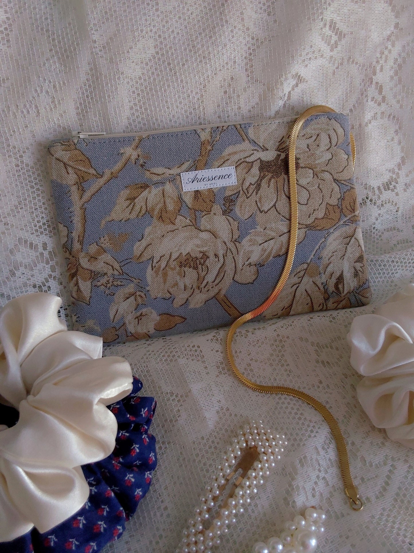 front view of floral blue beige upcycled pouch