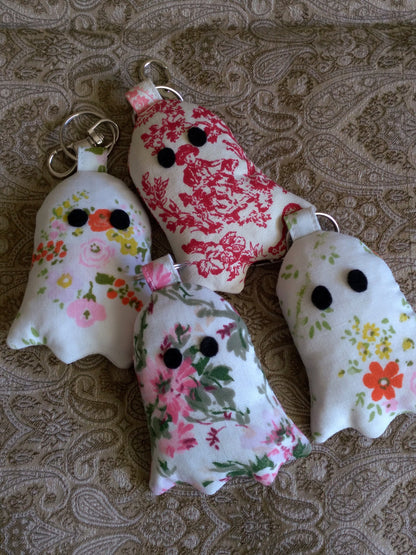 front view of upcycled ghost keychains laying flat