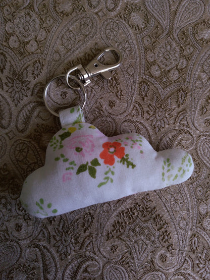 front view of orange pink florals white upcycled cloud keychain laying flat