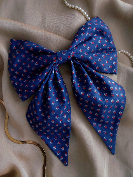 front view of calico navy cotton upcycled hair bow laying flat