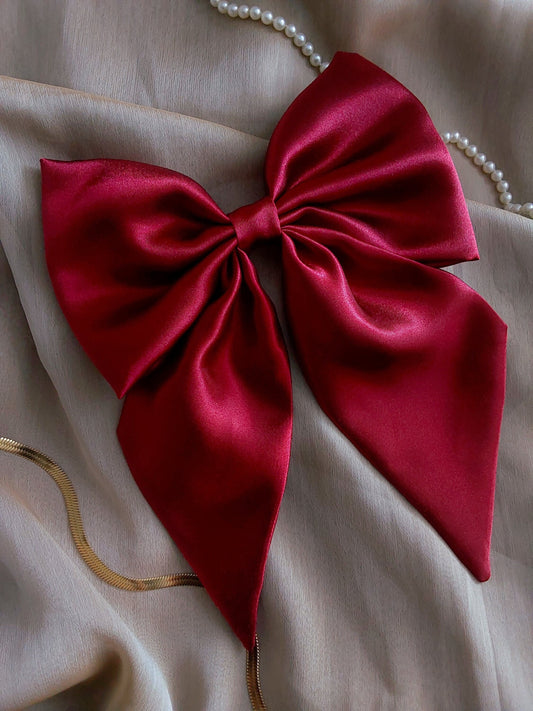 front view of red satin upcycled hair bow laying flat