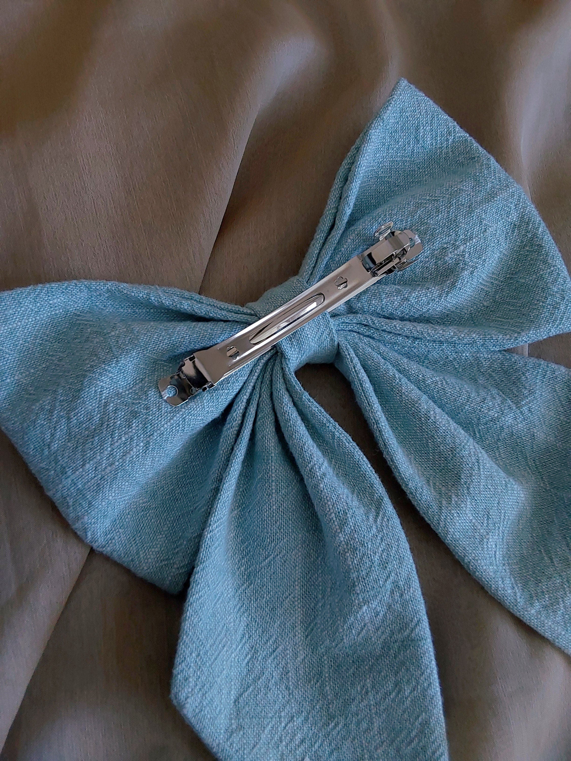 back view of light blue cotton upcycled hair bow laying flat